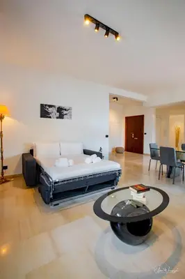a large room with a bed and a table at Magikrooms Domus in Rome