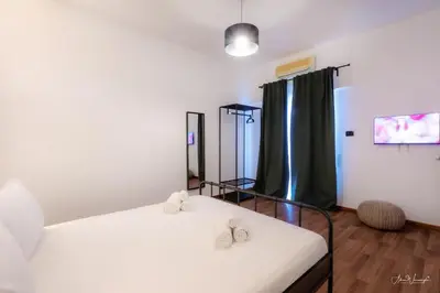a room with two beds with slippers on them at Magikrooms Domus in Rome