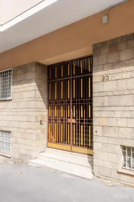 a building with a barred window on the side of it at Magikrooms Domus in Rome