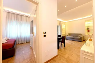 a bedroom with a bed and a desk in a room at Scarpellini home Parioli in Rome