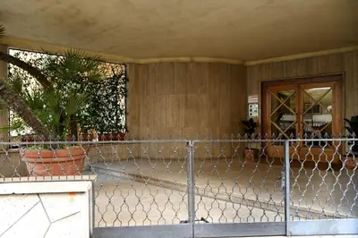 a fence in front of a house with plants at Scarpellini home Parioli in Rome