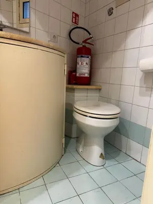 a bathroom with a toilet and a fire extinguisher at Scarpellini home Parioli in Rome