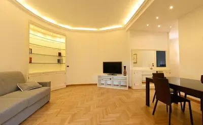 a living room with a couch and a table and a television at Scarpellini home Parioli in Rome