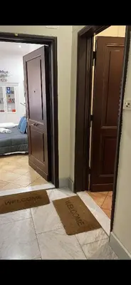 a room with an open door and a bedroom at All Suite Colosseo in Rome