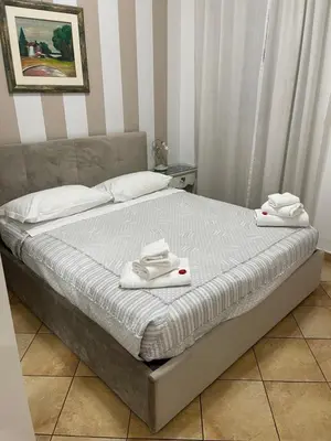 a bed with two white towels on top of it at All Suite Colosseo in Rome