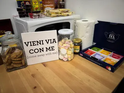 a sign sitting on top of a counter with food at All Suite Colosseo in Rome