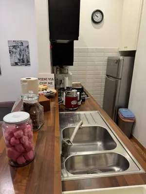 a kitchen with a sink and a counter top with a sink at All Suite Colosseo in Rome