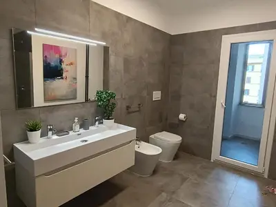 a bathroom with a sink and a toilet at Casa Vacanze Bianca - Metro A - Furio Camillo in Rome
