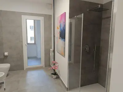 a bathroom with a shower and a toilet at Casa Vacanze Bianca - Metro A - Furio Camillo in Rome