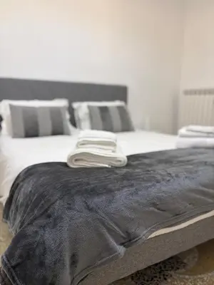 a bed with two towels on top of it at Luxury Apartment in Prati in Rome