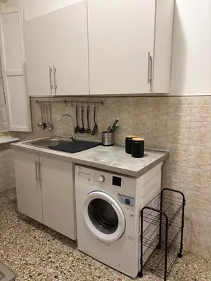 a kitchen with a washing machine and a sink at Luxury Apartment in Prati in Rome
