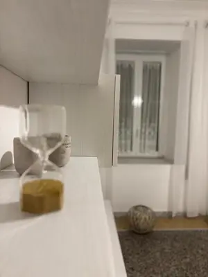 a kitchen counter with an hourglass sitting on top of it at Luxury Apartment in Prati in Rome