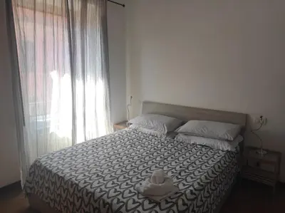a bedroom with a bed with a stuffed animal on it at Bikehouse in Rome