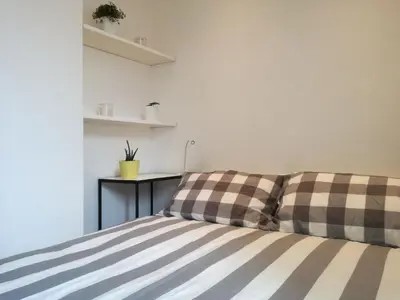 a bed with checkered pillows in a room at Bikehouse in Rome