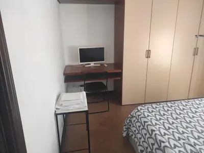 a bedroom with a desk with a computer and a bed at Bikehouse in Rome