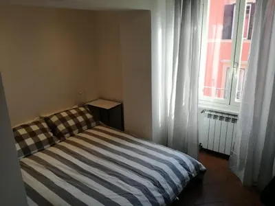 a bed sitting in a room with a window at Bikehouse in Rome