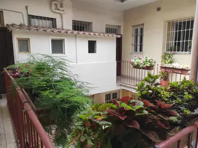 a balcony of a building with flowers and plants at Bikehouse in Rome