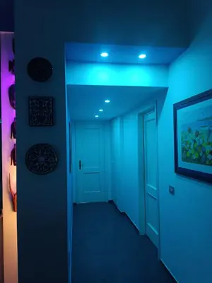a hallway with a blue ceiling and a door at large Vatican loft near the metro in Rome