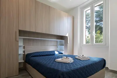 a bedroom with a blue bed with two towels on it at Rooma Roman Nest Garbatella - metro B line in Rome