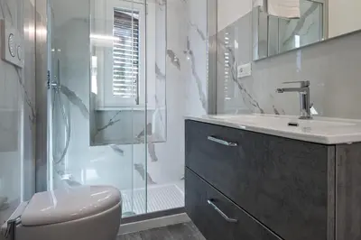 a bathroom with a toilet and a sink and a shower at Rooma Roman Nest Garbatella - metro B line in Rome