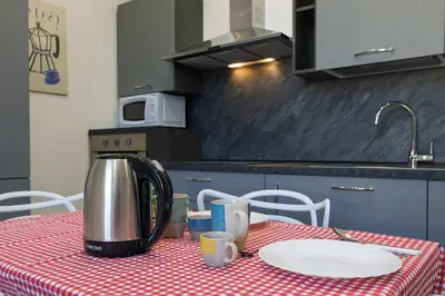 a kitchen with a table with a coffee pot on it at Rooma Roman Nest Garbatella - metro B line in Rome