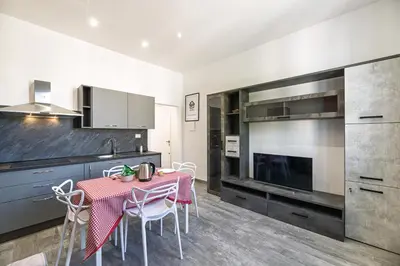 a kitchen with a table and chairs in a room at Rooma Roman Nest Garbatella - metro B line in Rome
