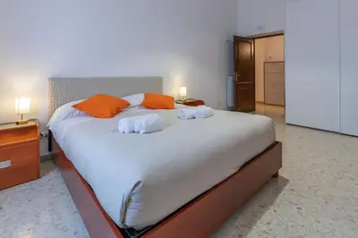 a bedroom with a large bed with orange pillows at Haven25 in Rome