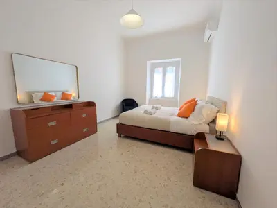 a bedroom with a bed and a dresser with a mirror at Haven25 in Rome