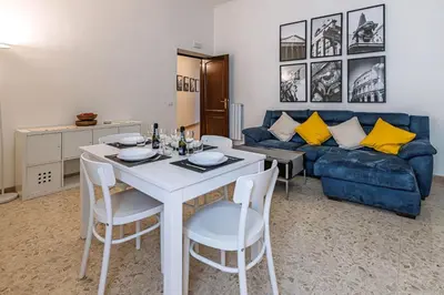 a living room with a table and a blue couch at Haven25 in Rome
