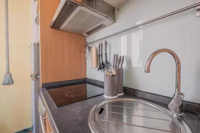a kitchen with a sink and a counter with utensils at Roman Forum apartament in Rome