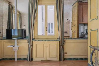 a room with a door with a tv and a window at Roman Forum apartament in Rome