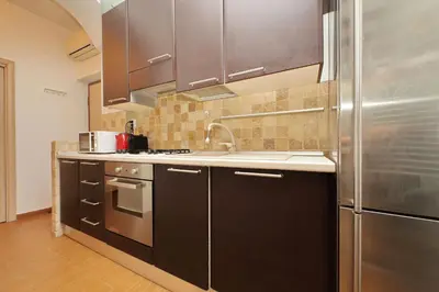 a kitchen with a sink and a refrigerator at Viale Trastevere by Halldis in Rome