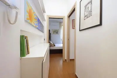 a room with a hallway with a white counter and a bed at Viale Trastevere by Halldis in Rome