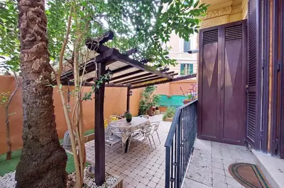 a wooden pergola with a table on a patio at Viale Trastevere by Halldis in Rome