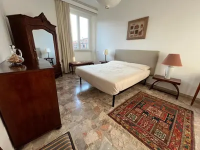 a bedroom with a bed and a mirror and a rug at CasAdelia in Rome