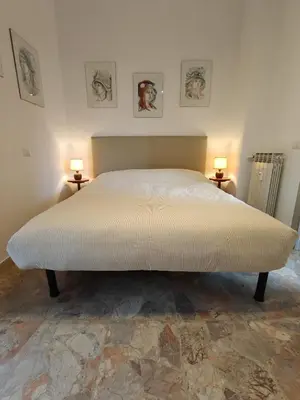 a bed in a bedroom with two lamps on two tables at CasAdelia in Rome