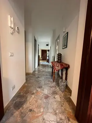 a hallway with a tile floor and a table at CasAdelia in Rome