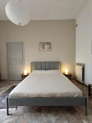 a large bed in a bedroom with two lamps at CasAdelia in Rome
