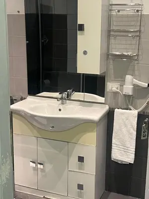 a bathroom with a white sink and a mirror at Sweet Home Inn in Rome