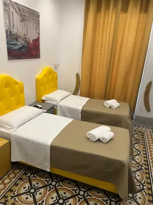 two beds in a hotel room with towels at Sweet Home Inn in Rome