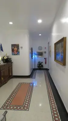 a room with a hallway with a rug on the floor at Sweet Home Inn in Rome