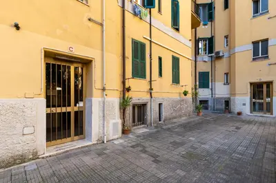 a building with a large door in a courtyard at Vatican Essence in Rome