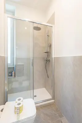a bathroom with a shower with a toilet and a sink at Vatican Essence in Rome