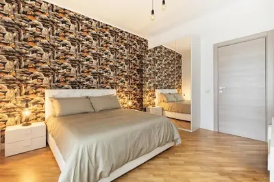 a bedroom with a bed and a stone wall at A Casa di Nico - Metro B1 Conca d 'Oro in Rome