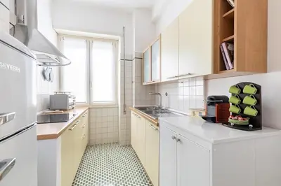 a white kitchen with a sink and a window at A Casa di Nico - Metro B1 Conca d 'Oro in Rome