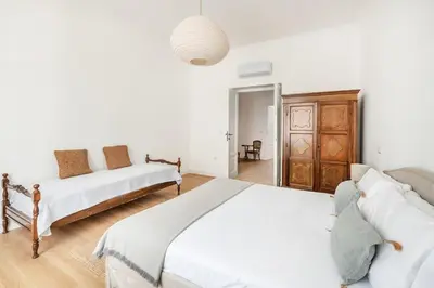 a bedroom with two beds and a couch at Davìta - Casa Leda in Rome