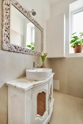 a bathroom with a white sink and a mirror at Davìta - Casa Leda in Rome