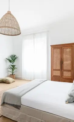 a bedroom with a large bed and a potted plant at Davìta - Casa Leda in Rome