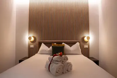 a bedroom with a bed with towels on it at Domus Augusti in Rome