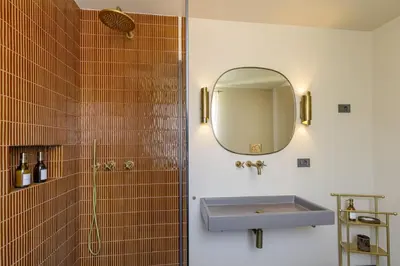 a bathroom with a sink and a mirror at Daplace - Palazzo Serpe Suites near Colosseum in Rome